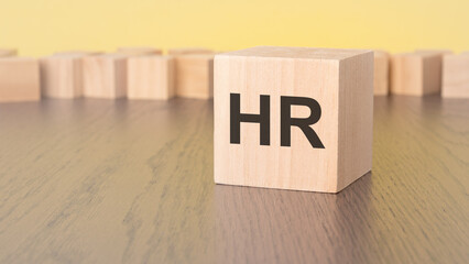 letter HR on wooden cube with copy space