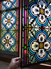 Opening an old stained glass window