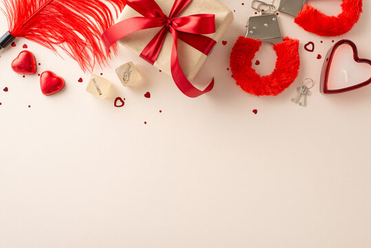 Sensual delights for a passionate celebration. Top view of adult shop treasures: fuzzy handcuffs, feather tickler, gift box, dice game, heart candle, candies, confetti on pastel peach. Perfect for ads