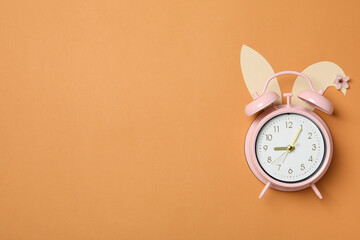 Pink alarm clock on a light background