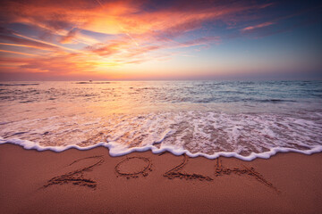 Happy New Year 2024 concept, lettering on the beach. Written text on the sea beach at sunrise. - obrazy, fototapety, plakaty