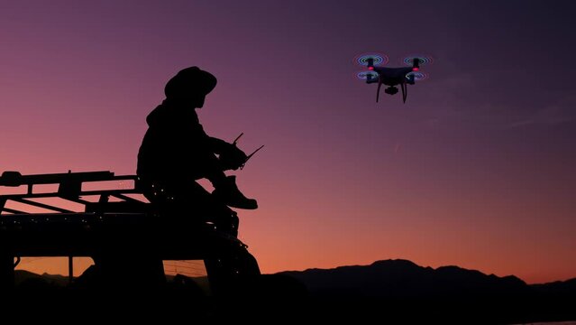 Young Man Hiker Controlling flying drone with help remote control application on cellular to shoot video of scenery nature landscape . Male bearded sits on Roof Car explore flying with copter. Outdoor