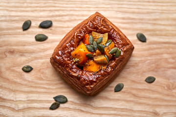 Spandauer pastry with pumpkin, roasted seeds and blue cheese cream. Top view