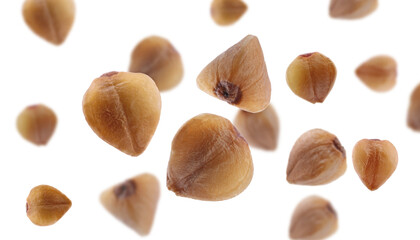 Buckwheat falling on white background. Grains in air