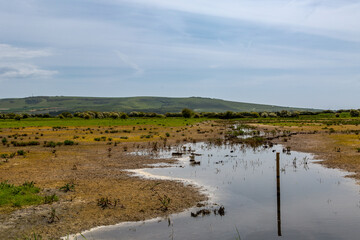 Fototapeta na wymiar A rural Sussex landscape with a water logged field