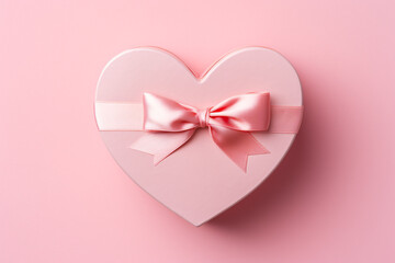 Top view of heart shaped gift box on pink background