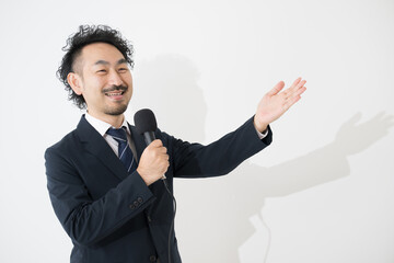 Businessman speaking with microphone Image of the presenter