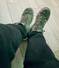 Selfie of a man's feet in green sneakers