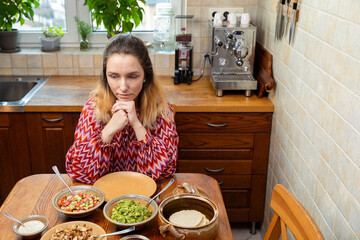 Woman at the table with homemade vegan Mexican cuisine food.