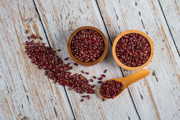 Red beans isolated on spoon and cup wooden on wooden background