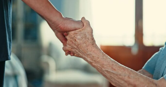 Closeup, senior person and holding hands with caregiver for support, care and empathy in retirement. People, nurse and patient with consultation, counselling and kindness with help in nursing home