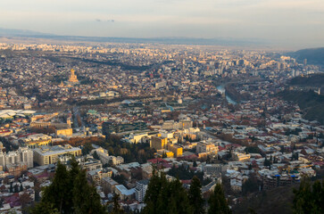 Fototapeta na wymiar Tbilisi at sunset panoramic view from Mtatsminda Park
