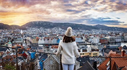 A tourist woman on a sightseeing trip enjoys the beautiful panoramic winter sunrise view of the...