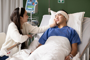 The man looks at his wife, appreciating her presence during his recovery.