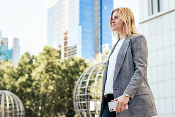 Confident businesswoman in a suit on her way to the office