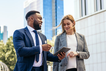 Multiracial business people having a casual business conversation outdoors