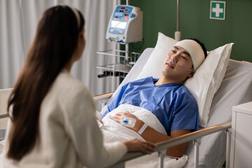 Engrossed, the man listens intently to his wife's comforting words. The man looks at his wife with gratitude and love in the hospital room
