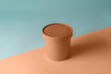 Empty paper Biodegradable cup container for food and soup on the background of Trendy color of year 2024 - Peach Fuzz.