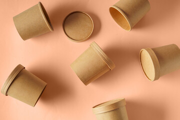 Empty paper Biodegradable cups containers for food and soup on the background of Trendy color of year 2024 - Peach Fuzz.