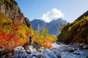Woman with Raised Arms Standing in the Colorful Albanian Alps