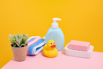 Hygienic supplies, rubber yellow duck, pink natural soap and shower gel.
