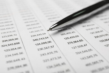 Pen on accounting document with data, closeup