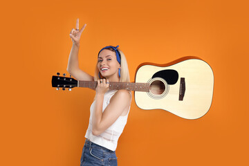 Happy hippie woman with guitar showing peace sign on orange background