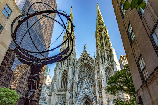 New York, USA; May 31, 2023: The famous giant Atlas holding the planet Earth on Fifth Avenue in the Big Apple in front of St. Patrick's Cathedral.