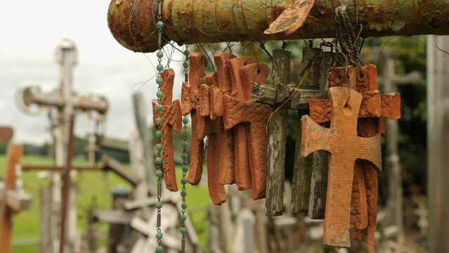 Clay and wooden crosses gently swaying at the Hill of Crosses in Lithuania.