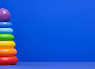 Colorful pyramid toy with colored rings. Copy space for text. Fun childhood.