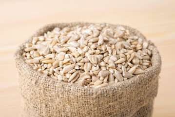 Close up shot of sunflower seeds in linen bag. Cooking with peeled sunflower grain, adding to pastry