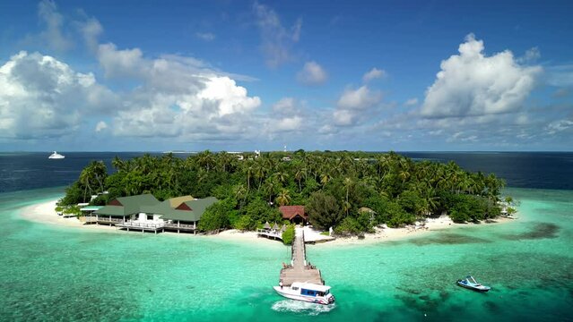 Tropical Island Paradise - Malahini Kuda Bandos, Maldives: Aerial drone rise up, reveal island and Bandos sister island backdrop