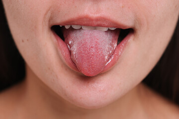 Closeup view of woman showing her tongue - obrazy, fototapety, plakaty