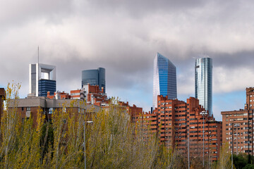Cityscape with four modern towers and apartment buildings in the city of Madrid in Spain