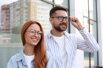 Portrait of happy couple in glasses outdoors