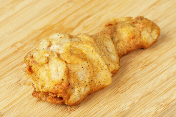 Fried Chicken Leg or Drumstick on a wooden Background Copy Space