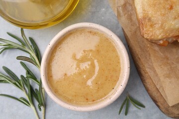 Delicious turkey gravy and rosemary on grey table, top view