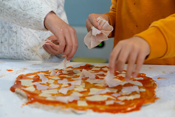 Children hands cooking pizza