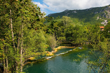 Travertine pools in the River Una as it flows away from the Small Waterfalls at Martin Brod in...