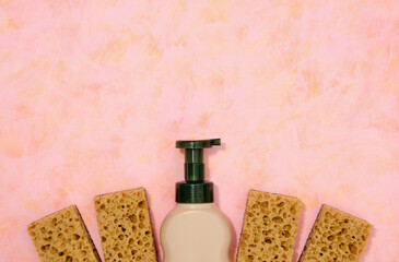 Flat lay, copy space for text. Detergent dispenser and dishwashing sponges.