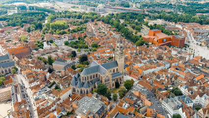 Bruges, Belgium. Cathedral of St. Salvator - 14th-century cathedral with a Gothic tower. Panorama of the city center from the air. Cloudy weather, summer day, Aerial View