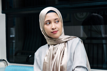 Asian muslim woman on subway train transit system public. Public transport concept