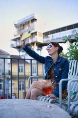 Tourist visiting Lisbon, Portugal - Happy woman taking a selfie on a bar terrace - Travel, tourism and blogger concept