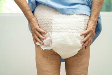 Asian senior woman patient wearing incontinence diaper in hospital, healthy strong medical concept.