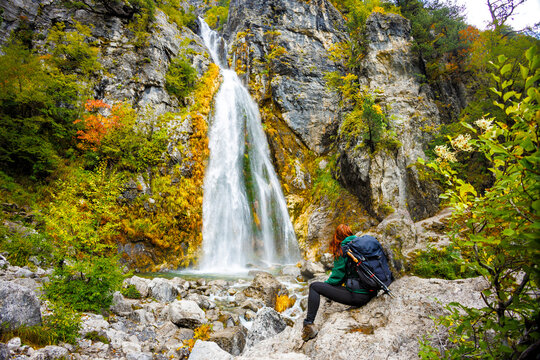 Woman Sitting in Front of the Waterfall in Theth, Albania	