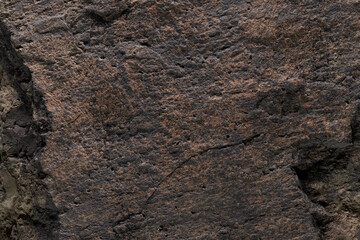 Brown stone texture, dark abstract background. Natural mineral rock close up details, empty backdrop with copy space for design