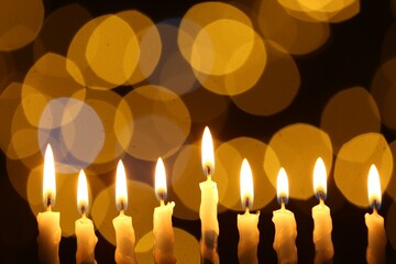 Hanukkah celebration. Burning candles against blurred lights © New Africa
