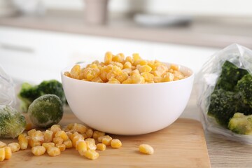 Frozen vegetables on wooden table in kitchen, closeup