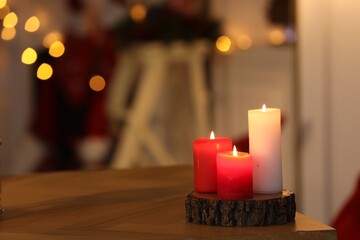 Beautiful burning candles on table indoors, space for text. Cozy atmosphere