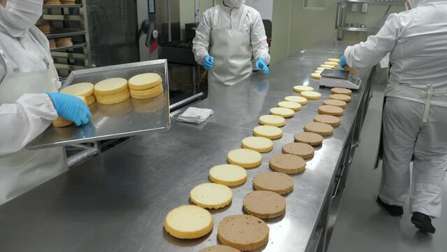 Baking process - soaking sponge cake layers.